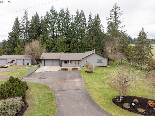 view of front of home with a front yard and an attached garage