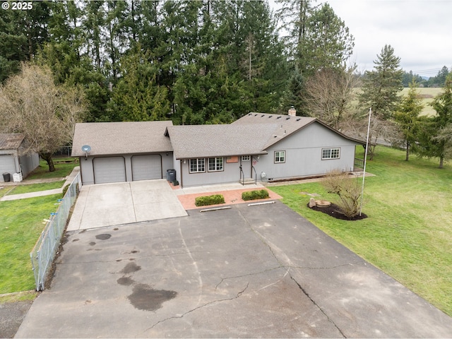 single story home featuring a garage, concrete driveway, a front yard, and fence