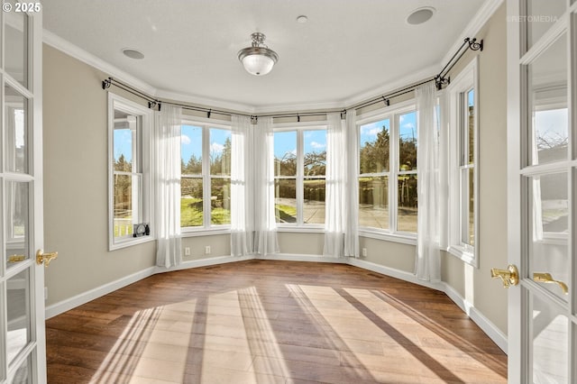 unfurnished sunroom featuring french doors