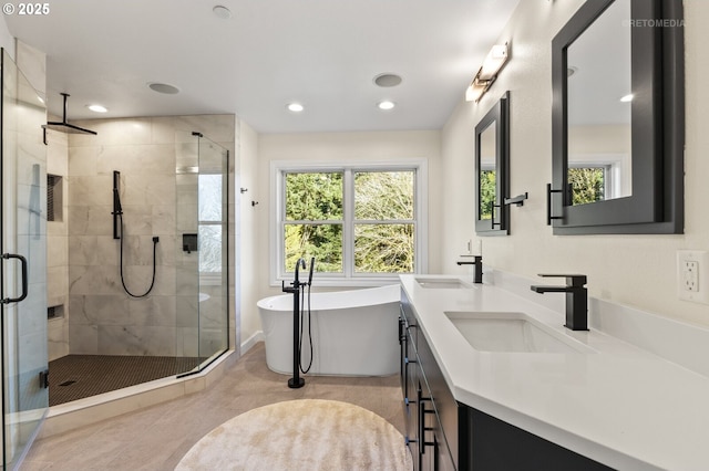 full bath featuring double vanity, a stall shower, a freestanding tub, and a sink