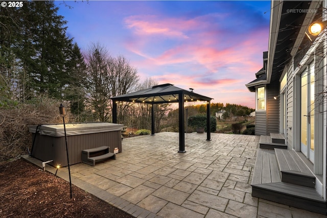 view of patio featuring a gazebo and a hot tub