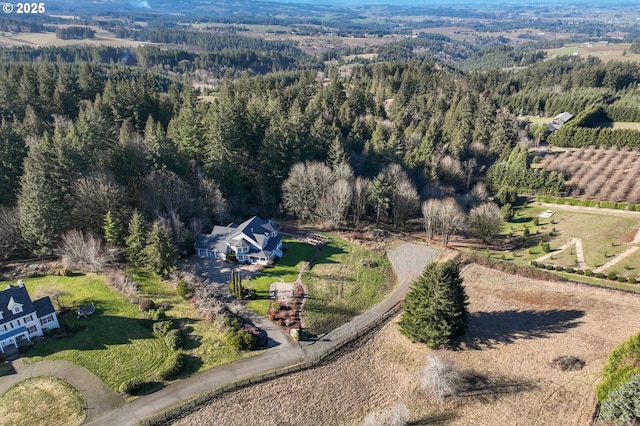 aerial view with a wooded view and a rural view