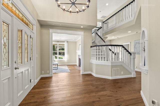 entryway featuring stairway, wood finished floors, and baseboards