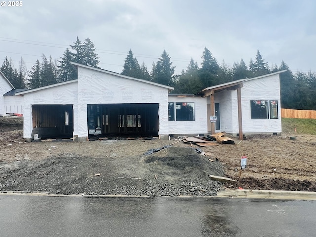 unfinished property featuring a garage