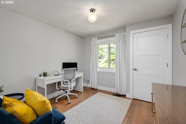 10701 SE Stevens Way, Happy Valley, OR 97086 - office with a textured ceiling, wood finished floors, and baseboards