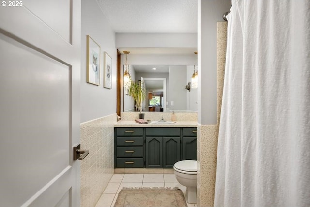 10701 SE Stevens Way, Happy Valley, OR 97086 - full bath with tile walls, toilet, tile patterned flooring, vanity, and wainscoting