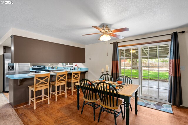 1911 SW Vista Pl, Pendleton, OR 97801 - dining room with light wood-style floors, ceiling fan, and a textured ceiling