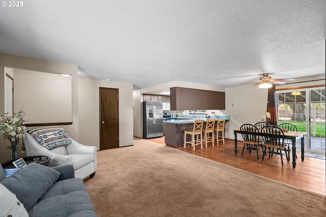 1911 SW Vista Pl, Pendleton, OR 97801 - living room featuring light carpet, a ceiling fan, and a textured ceiling
