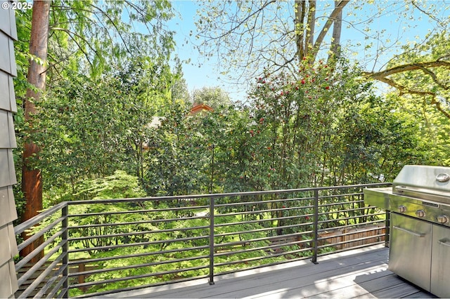 wooden terrace featuring a grill