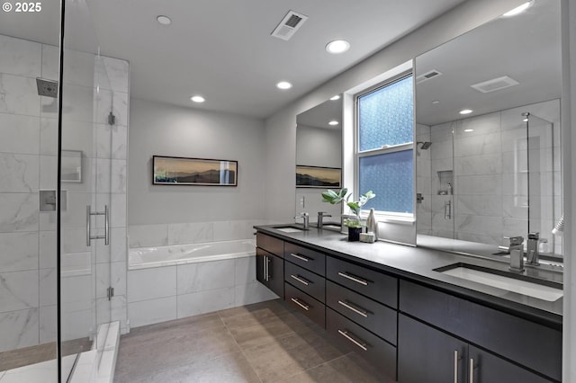 full bathroom with a bath, a shower stall, double vanity, recessed lighting, and tile patterned flooring