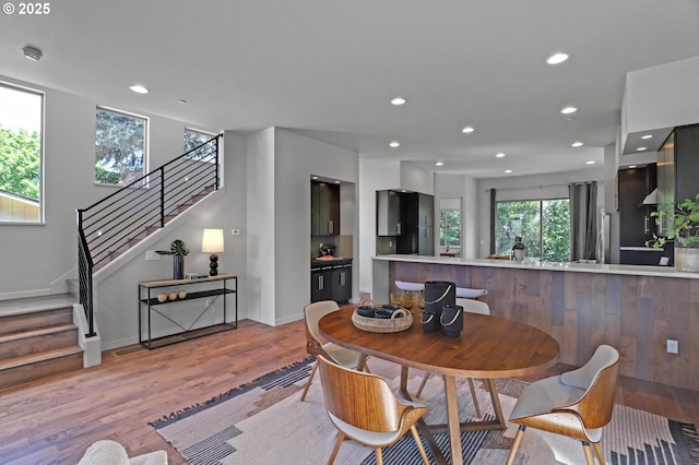 dining area with wood finished floors, stairway, recessed lighting, and baseboards