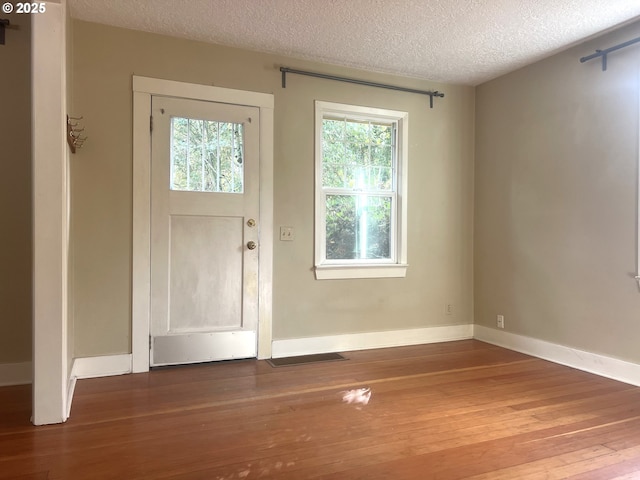 6433 NE 35th Ave, Portland, OR 97211 - entrance foyer featuring wood-type flooring, a textured ceiling, and healthy amount of natural light