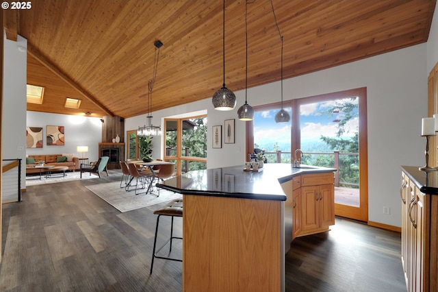 3758 Pine Canyon Dr, Eugene, OR 97405 - kitchen with a sink, dark wood-style floors, high vaulted ceiling, a kitchen breakfast bar, and open floor plan