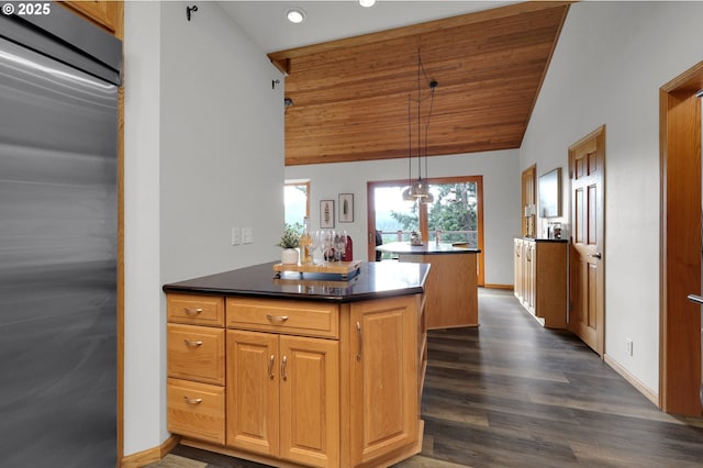 3758 Pine Canyon Dr, Eugene, OR 97405 - kitchen with refrigerator, vaulted ceiling, a peninsula, dark wood finished floors, and dark countertops
