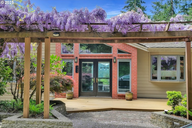 3758 Pine Canyon Dr, Eugene, OR 97405 - view of exterior entry featuring french doors, a deck, and brick siding
