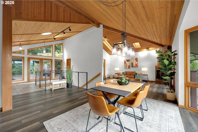 3758 Pine Canyon Dr, Eugene, OR 97405 - dining area with wood ceiling with exposed beams, wood finished floors, a chandelier, high vaulted ceiling, and baseboards