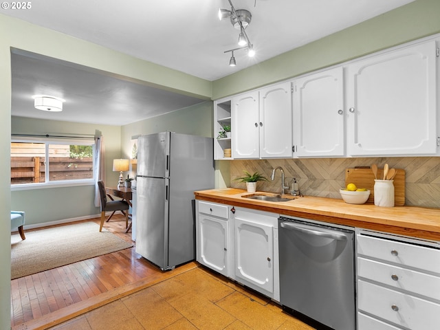 3516 N Missouri Ave, Portland, OR 97227 - kitchen with appliances with stainless steel finishes, wood counters, white cabinetry, tasteful backsplash, and open shelves