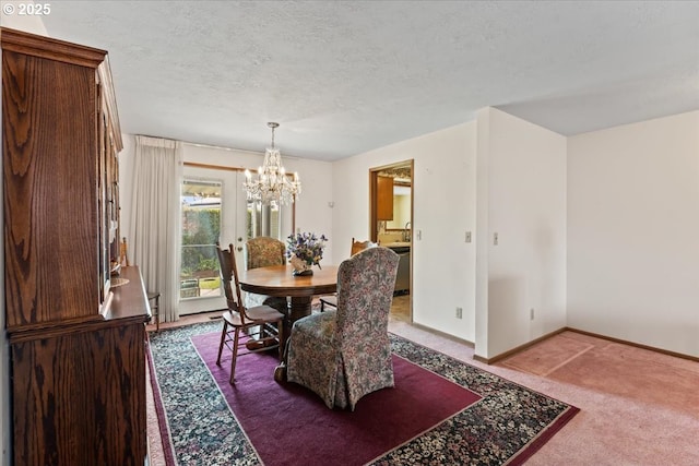 2242 W Hayes St, Woodburn, OR 97071 - carpeted dining room with baseboards, a notable chandelier, and a textured ceiling