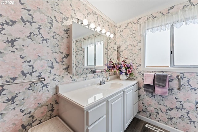 2242 W Hayes St, Woodburn, OR 97071 - bathroom featuring wood finished floors, wallpapered walls, ornamental molding, vanity, and visible vents