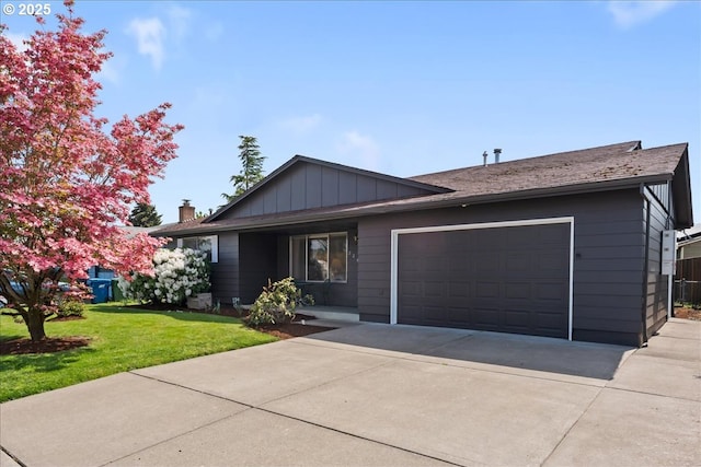 2242 W Hayes St, Woodburn, OR 97071 - ranch-style home with a front yard, driveway, an attached garage, and board and batten siding