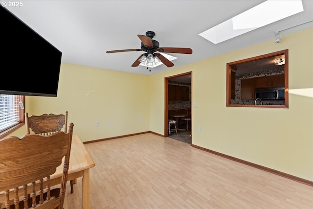 2242 W Hayes St, Woodburn, OR 97071 - interior space with a skylight, ceiling fan, baseboards, and light wood-style floors