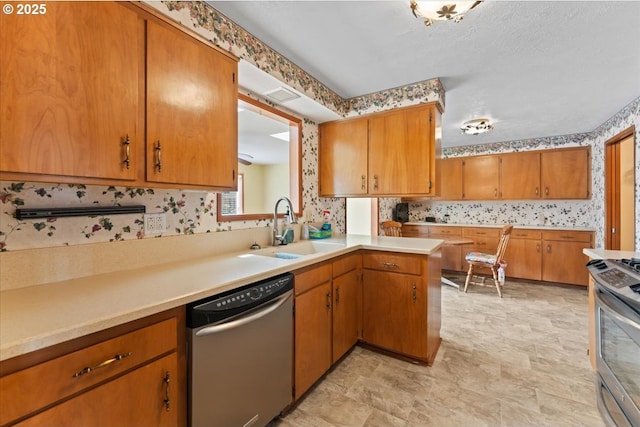 2242 W Hayes St, Woodburn, OR 97071 - kitchen with wallpapered walls, appliances with stainless steel finishes, light countertops, and a sink