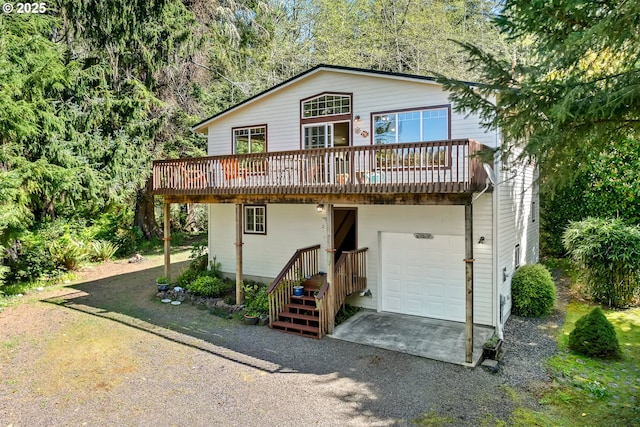 9320 Nehalem Rd, Manzanita, OR 97130 - back of house featuring a deck, an attached garage, and gravel driveway
