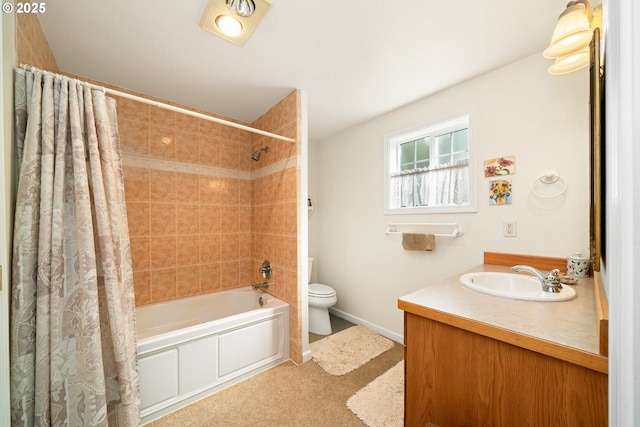 bathroom with vanity, baseboards, shower / bath combination with curtain, and toilet