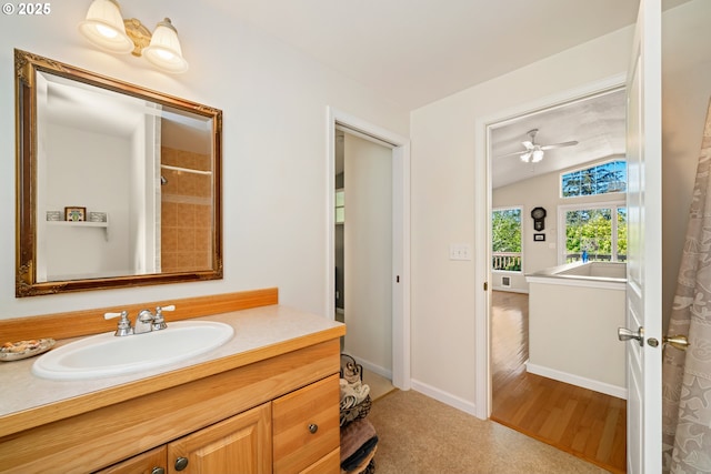full bath featuring vanity, baseboards, and wood finished floors