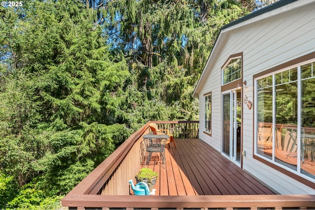 wooden terrace featuring outdoor dining space