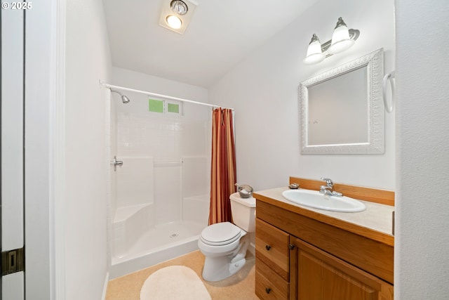 bathroom featuring vanity, toilet, and a stall shower