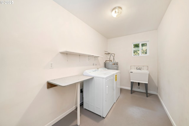 9320 Nehalem Rd, Manzanita, OR 97130 - washroom featuring laundry area, baseboards, water heater, and washing machine and dryer