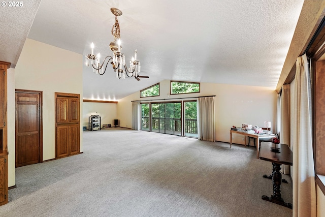 unfurnished living room featuring lofted ceiling, a textured ceiling, carpet flooring, and a chandelier