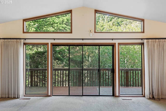 entryway featuring carpet floors, visible vents, and lofted ceiling