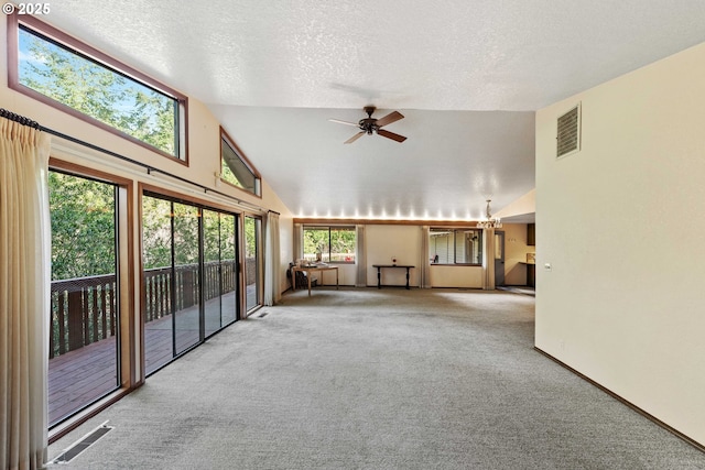 interior space featuring carpet floors, high vaulted ceiling, visible vents, and a textured ceiling