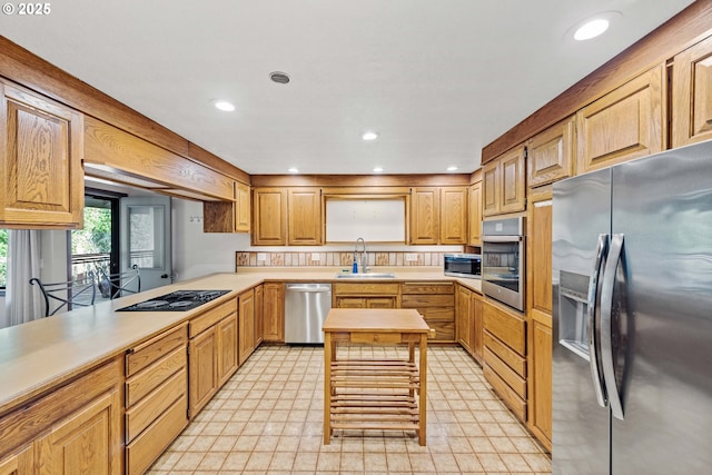 kitchen with stainless steel appliances, recessed lighting, light countertops, and a sink