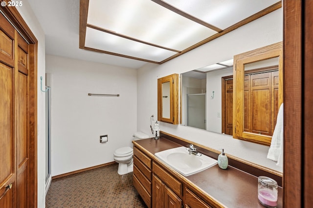 full bathroom with baseboards, toilet, a shower stall, and vanity