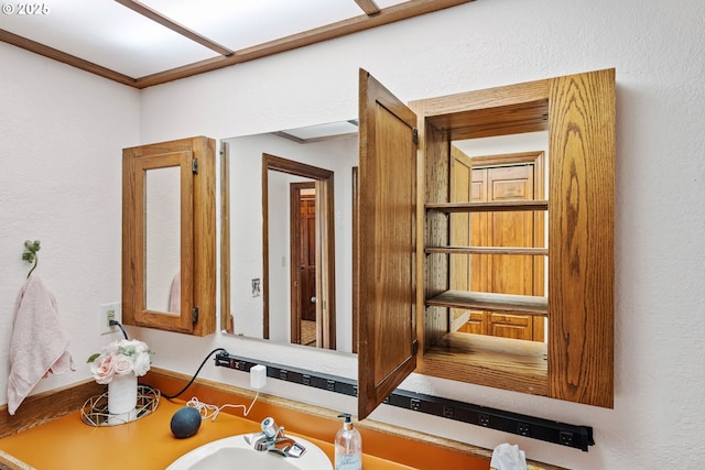 workout room with a sink and a textured wall