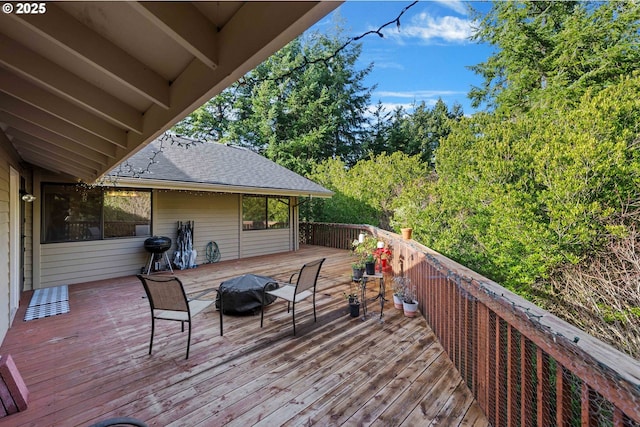 deck featuring an outdoor fire pit and a grill