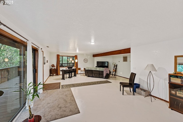 living room with concrete floors and baseboards