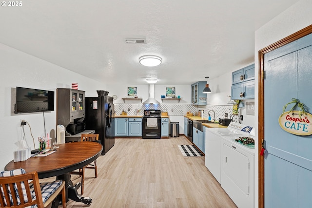 kitchen featuring tasteful backsplash, visible vents, washer and clothes dryer, light countertops, and black appliances