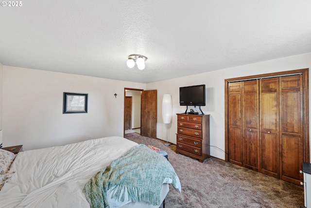 bedroom with a closet, light carpet, and a textured ceiling