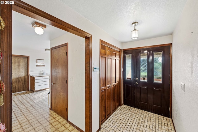 foyer with a textured ceiling