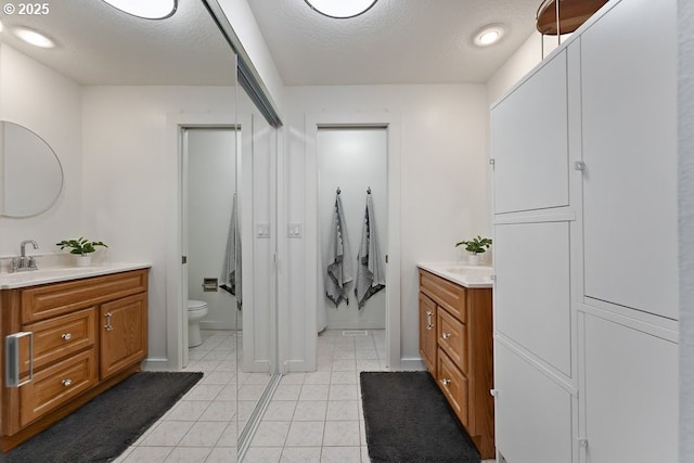 11595 SW Fairview Ln, Tigard, OR 97223 - full bathroom featuring vanity, tile patterned flooring, toilet, and a textured ceiling