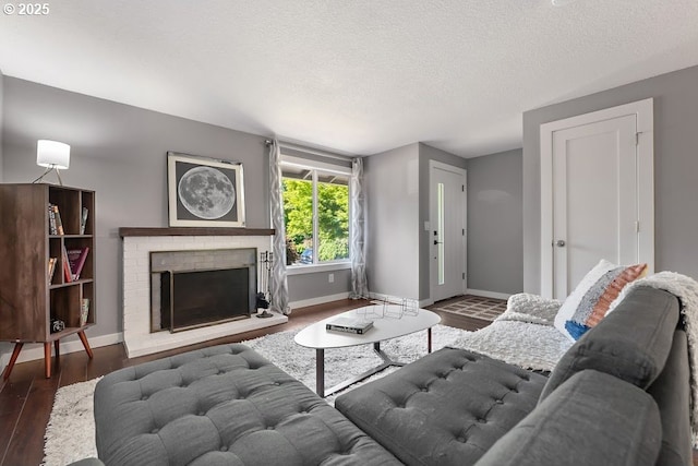 11595 SW Fairview Ln, Tigard, OR 97223 - living area with wood finished floors, a textured ceiling, baseboards, and a fireplace