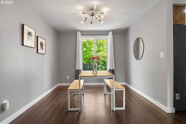 11595 SW Fairview Ln, Tigard, OR 97223 - dining room with a chandelier, a textured ceiling, dark wood-style flooring, and baseboards