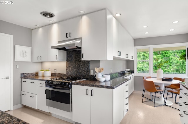 3132 SW Altadena Ter, Portland, OR 97239 - kitchen featuring under cabinet range hood, stainless steel range with gas cooktop, decorative backsplash, white cabinets, and recessed lighting