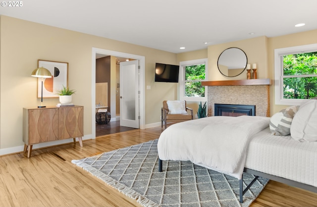 3132 SW Altadena Ter, Portland, OR 97239 - bedroom with wood finished floors, baseboards, a tiled fireplace, and recessed lighting