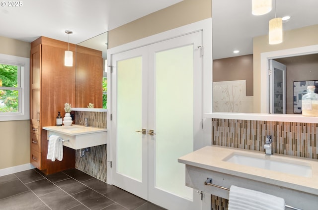 3132 SW Altadena Ter, Portland, OR 97239 - bathroom with decorative backsplash, a sink, and baseboards