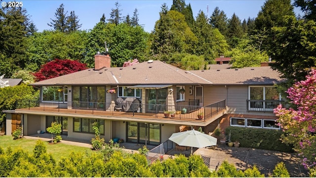 3132 SW Altadena Ter, Portland, OR 97239 - back of house with a chimney, a balcony, a patio area, and roof with shingles